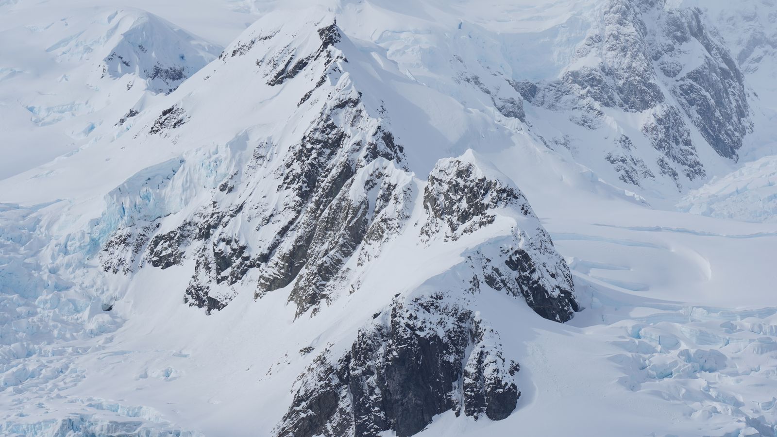Snow-covered mountain ridges and glacial ice.