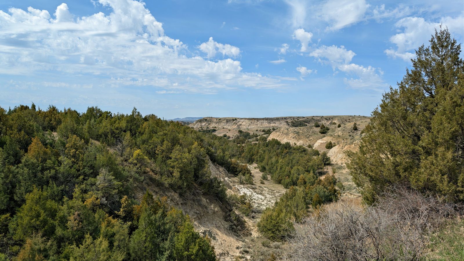 Rugged badlands under a blue sky in North Dakota.