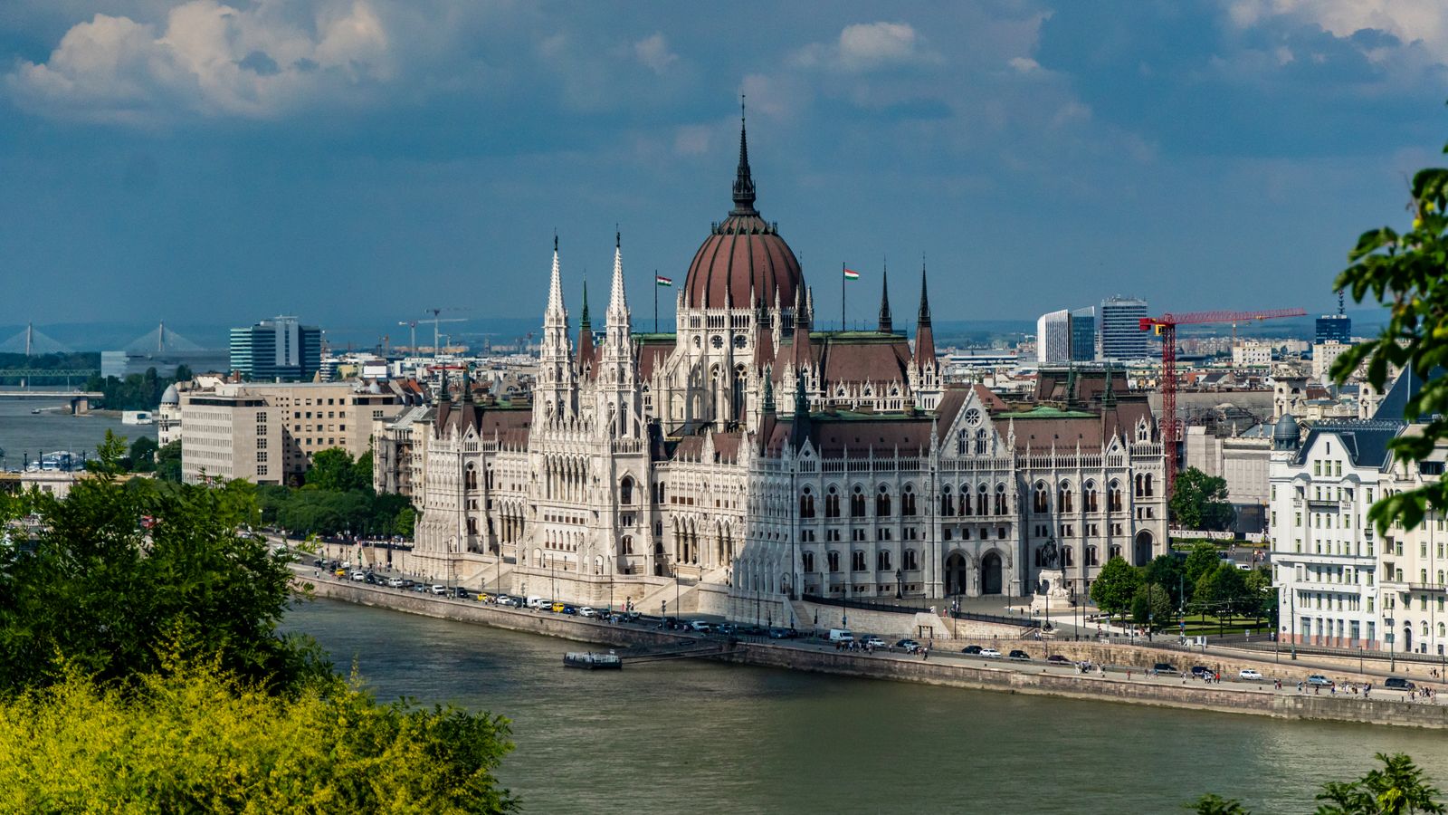 Hungarian Parliament Building beside the Danube River in Budapest under a blue sky