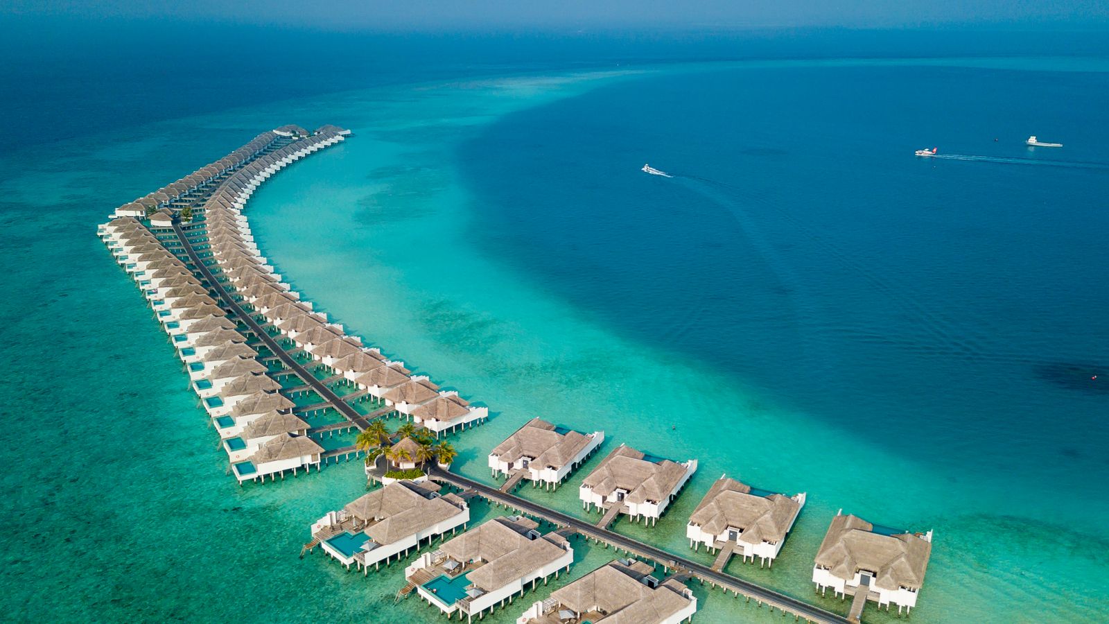 Overwater villas on a turquoise lagoon in Baa Atoll, Maldives.