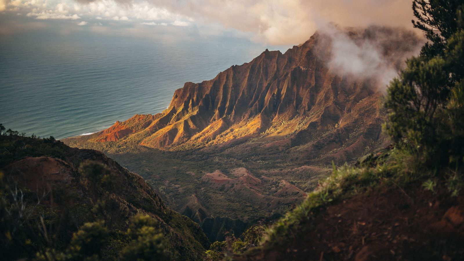 Kalalau Valley ridges and ocean on Kauai's Na Pali coast at golden hour.