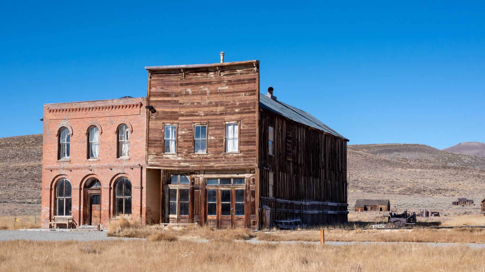 Weathered brick and wooden buildings in a dry, open landscape.