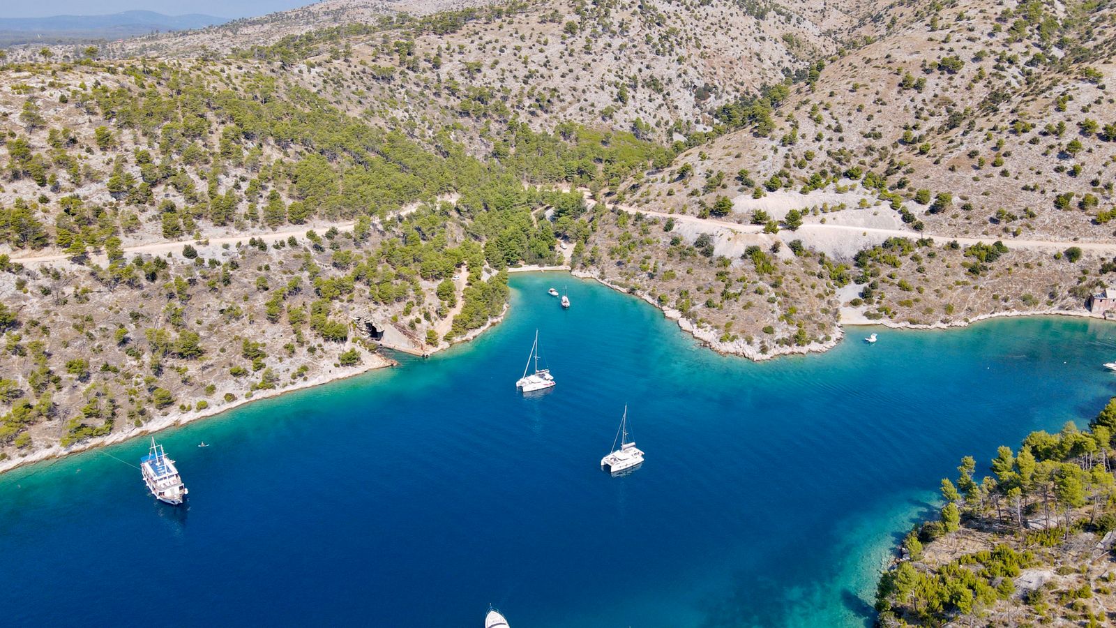 Sailboats in a turquoise bay near Nerežišća, Croatia.