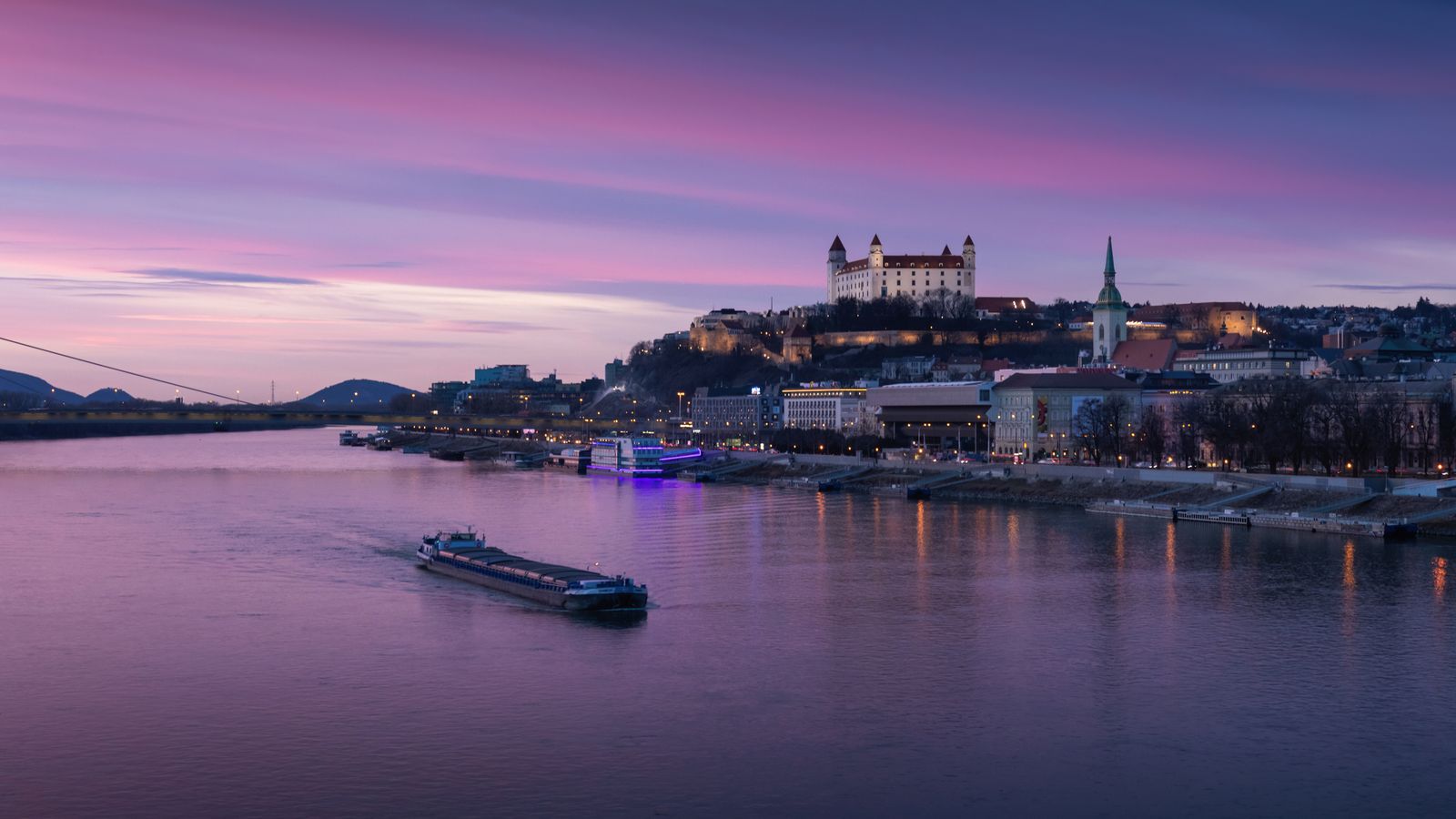 Bratislava Castle and riverfront skyline at dusk over the Danube