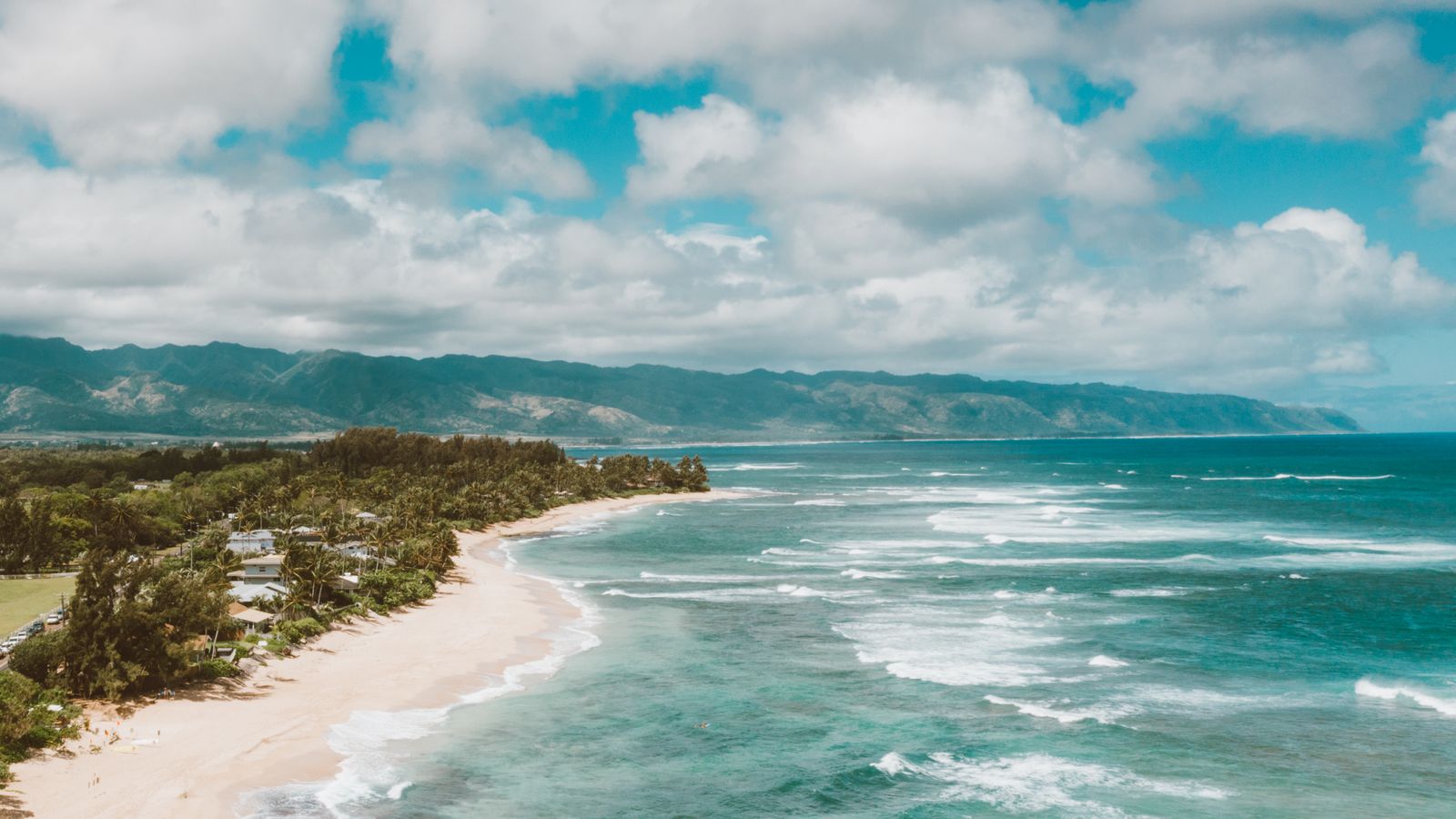 Aerial view of a North Shore Oahu beach with lines of waves
