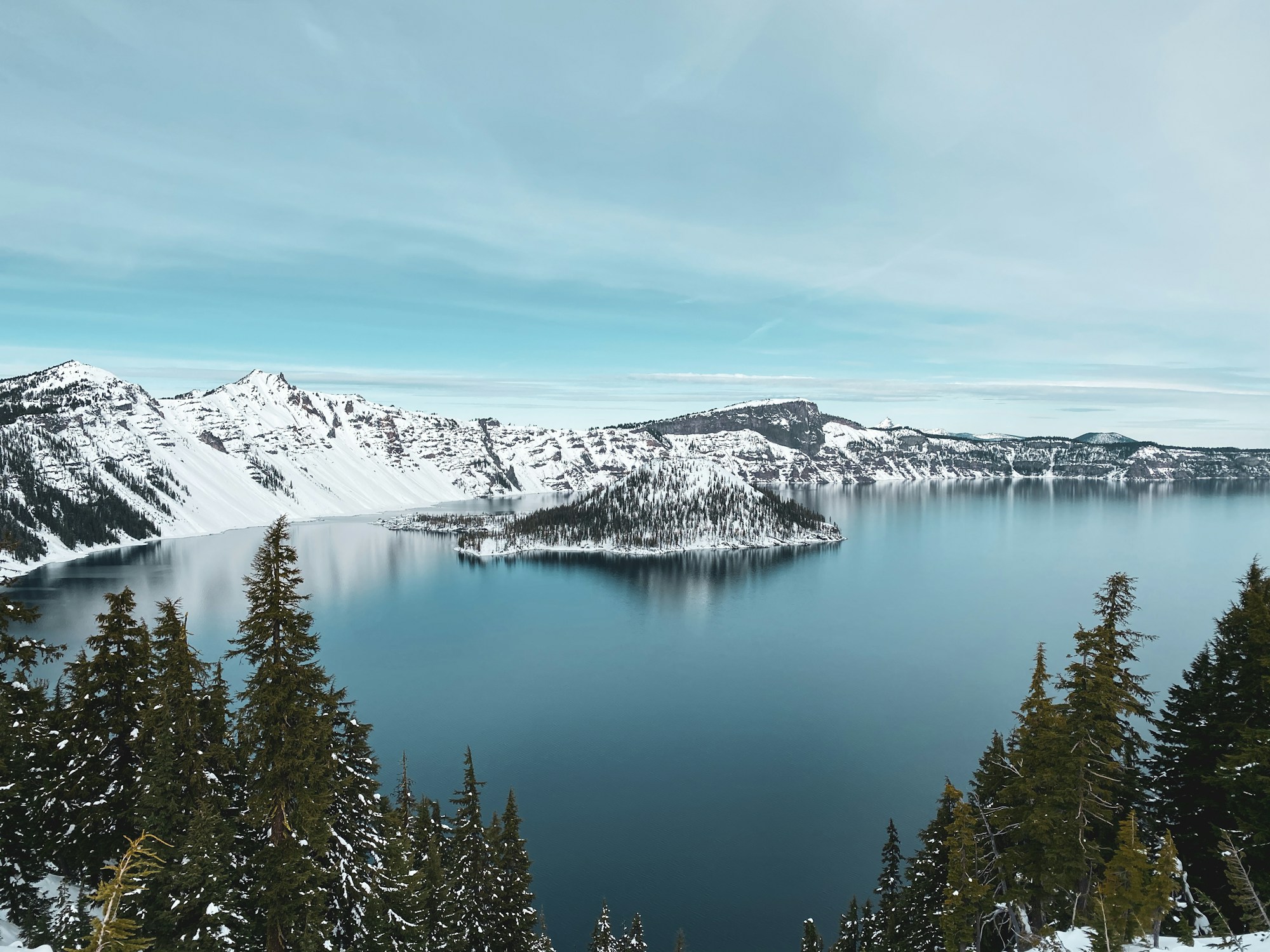 Snowy rim above the deep blue Crater Lake caldera