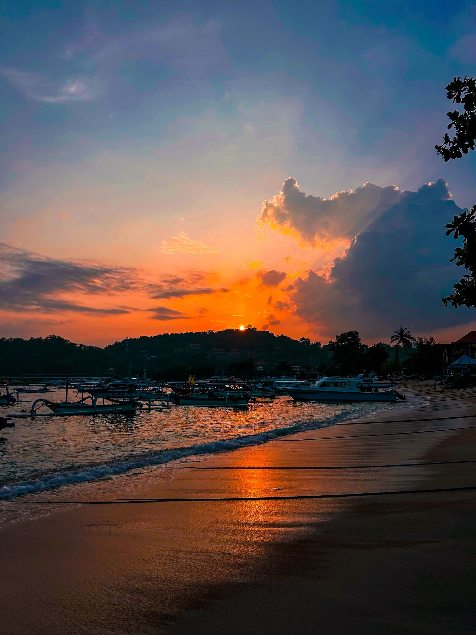 Outrigger fishing boats moored off a beach at sunset in east Bali, Indonesia