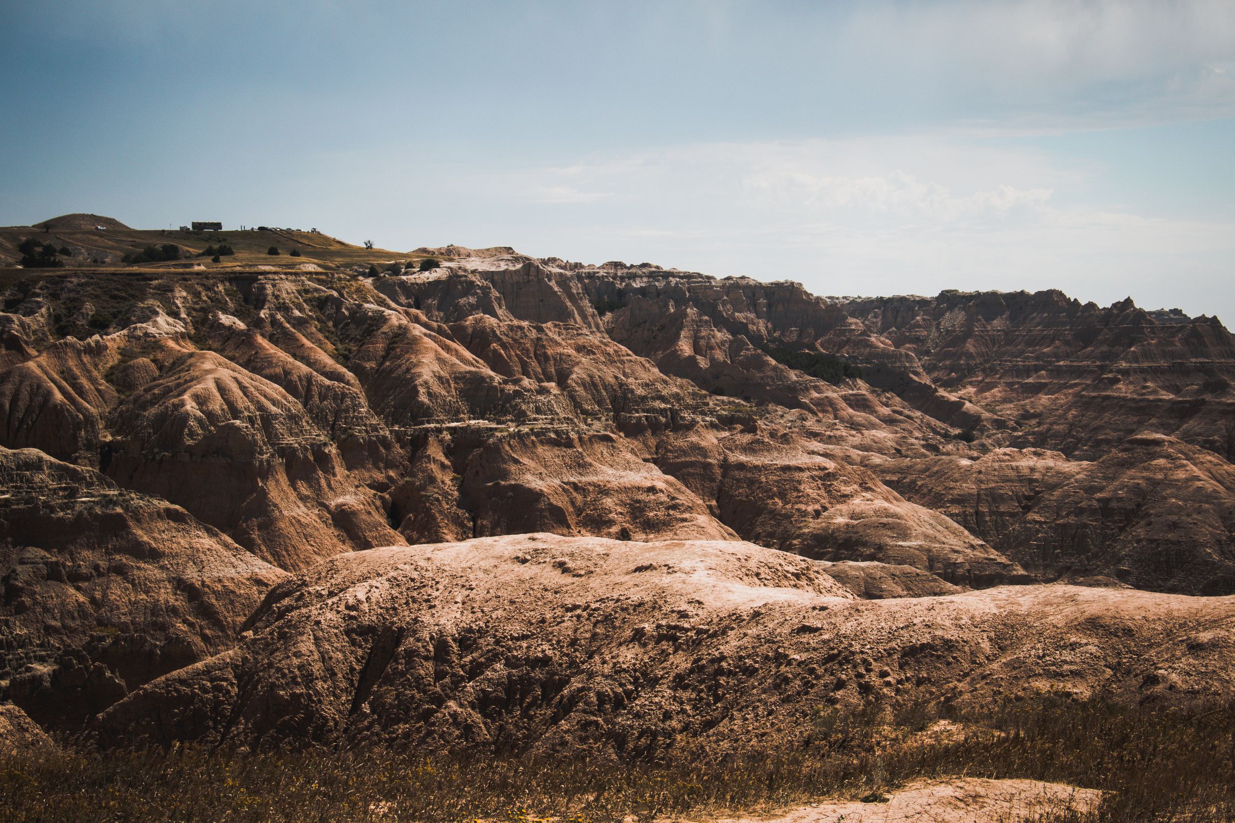 Layered rock formations and grassland at Badlands National Park, South Dakota